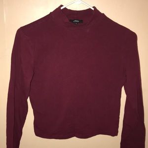 Long sleeve maroon crop top.